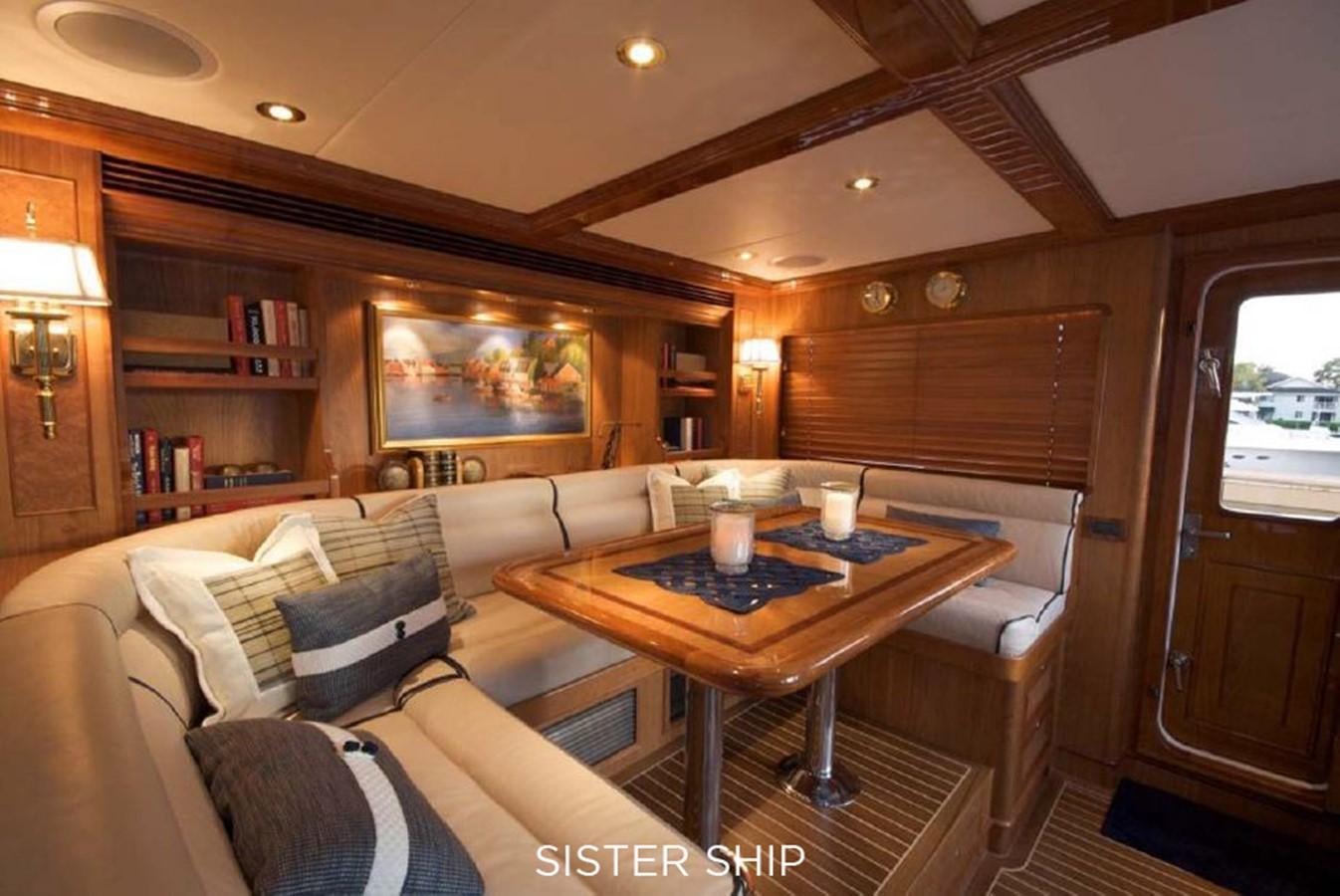 a living room with a table and chairs aboard 800 MY Yacht for Sale