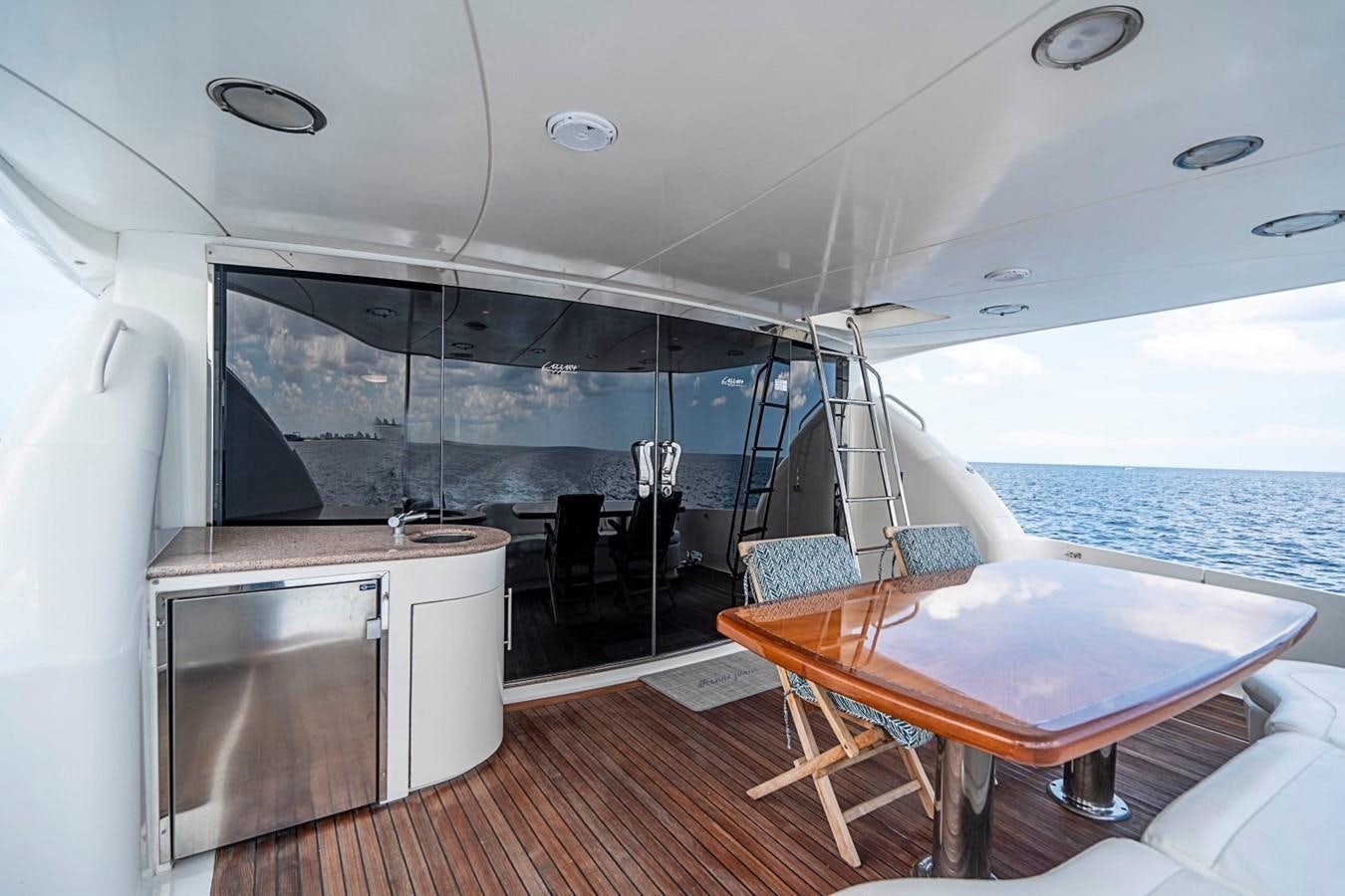 a large living room with a large glass wall aboard RENDEZVOUS Yacht for Sale