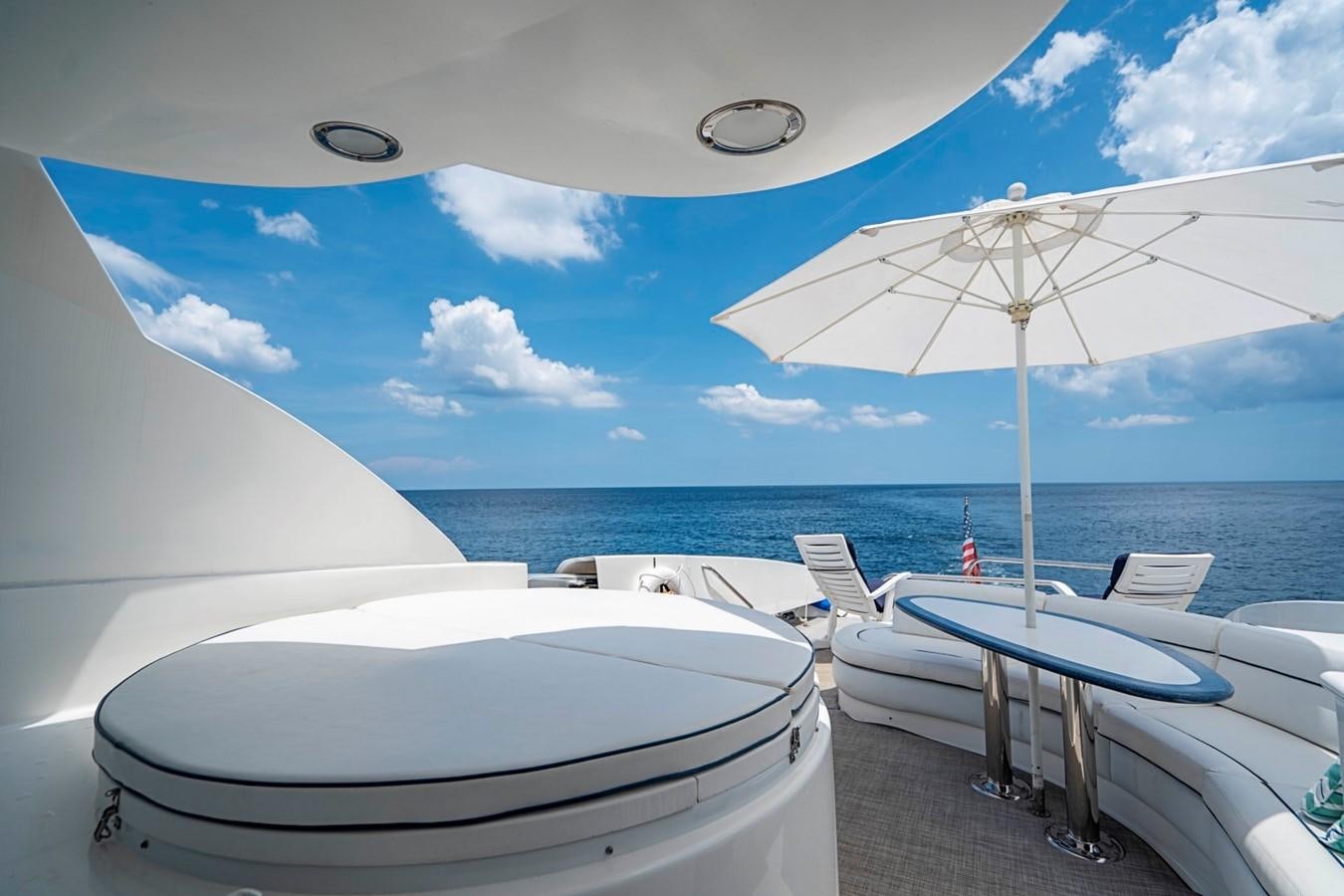 a table and chairs on a beach aboard RENDEZVOUS Yacht for Sale