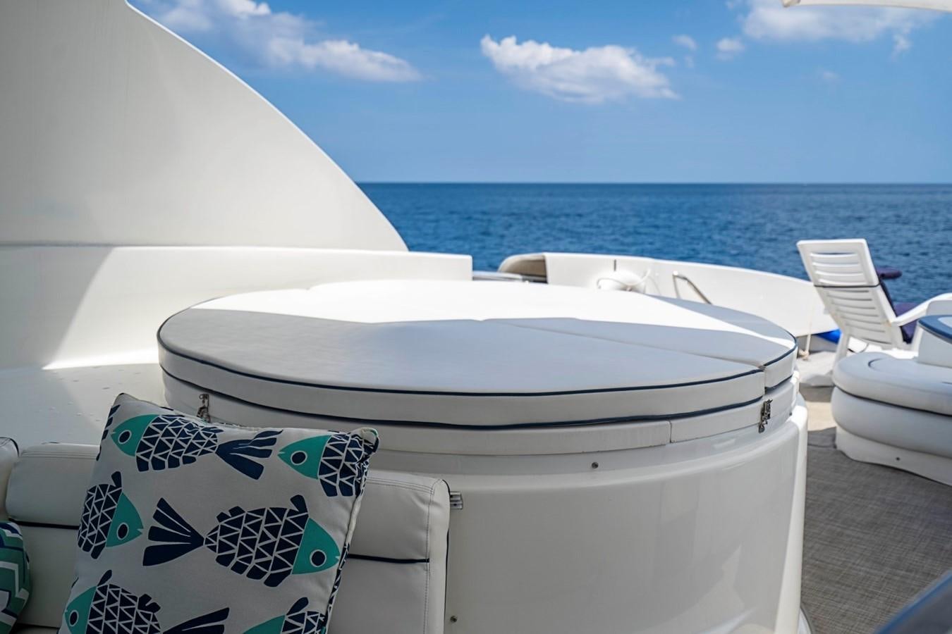 a white lounge chair on a deck overlooking the ocean aboard RENDEZVOUS Yacht for Sale