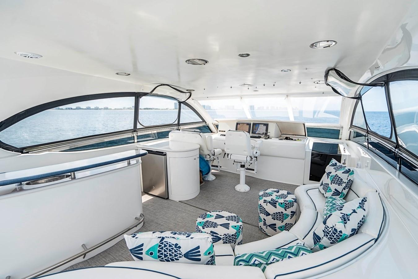 a boat with a large deck aboard RENDEZVOUS Yacht for Sale