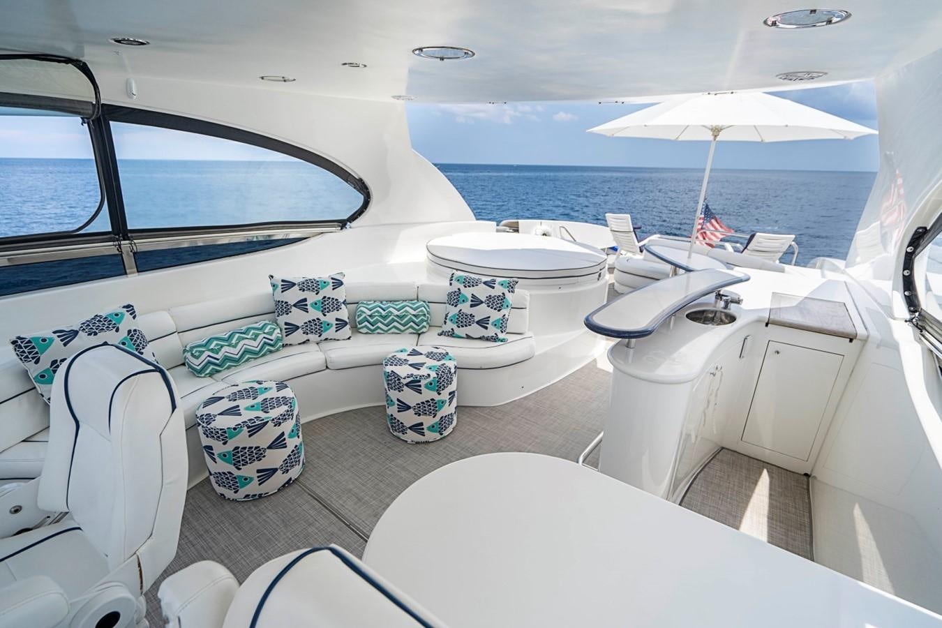 a boat with a table and chairs on it aboard RENDEZVOUS Yacht for Sale