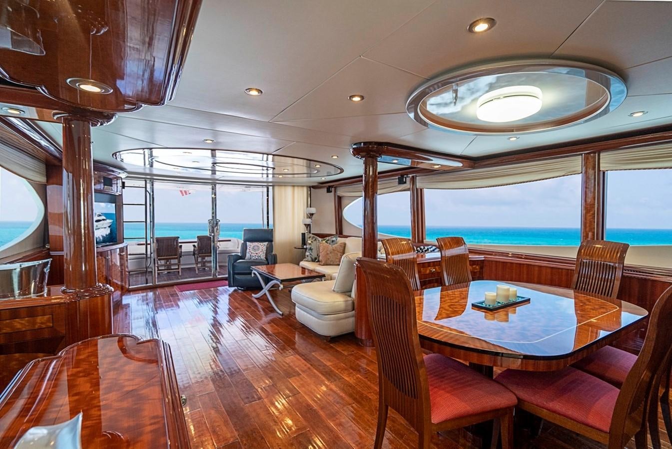 a large living room with a wood floor and a large window aboard RENDEZVOUS Yacht for Sale