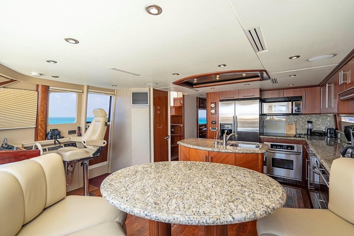 a kitchen with a table and chairs aboard RENDEZVOUS Yacht for Sale