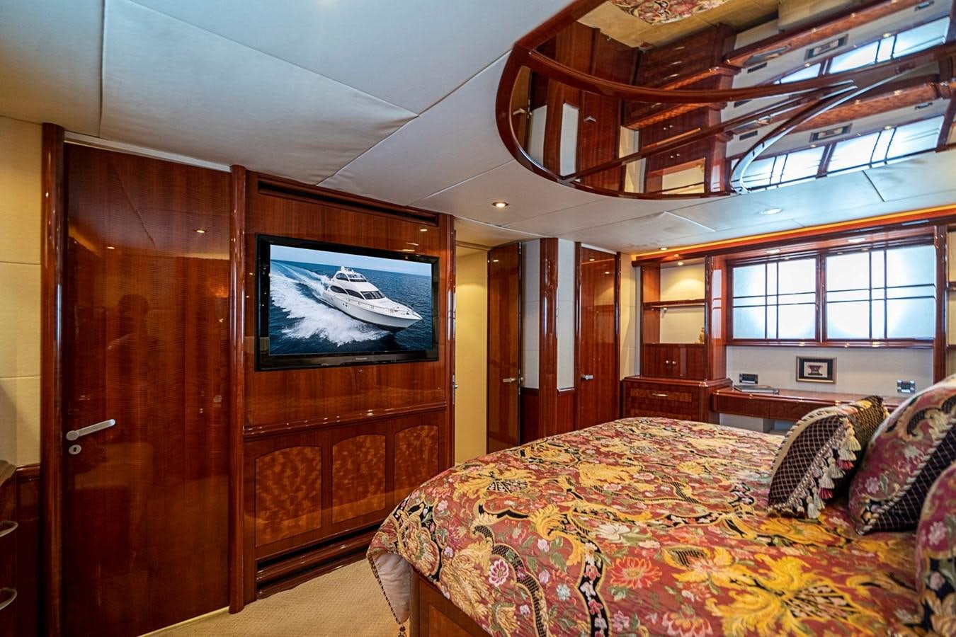 a bedroom with a television on the wall aboard RENDEZVOUS Yacht for Sale