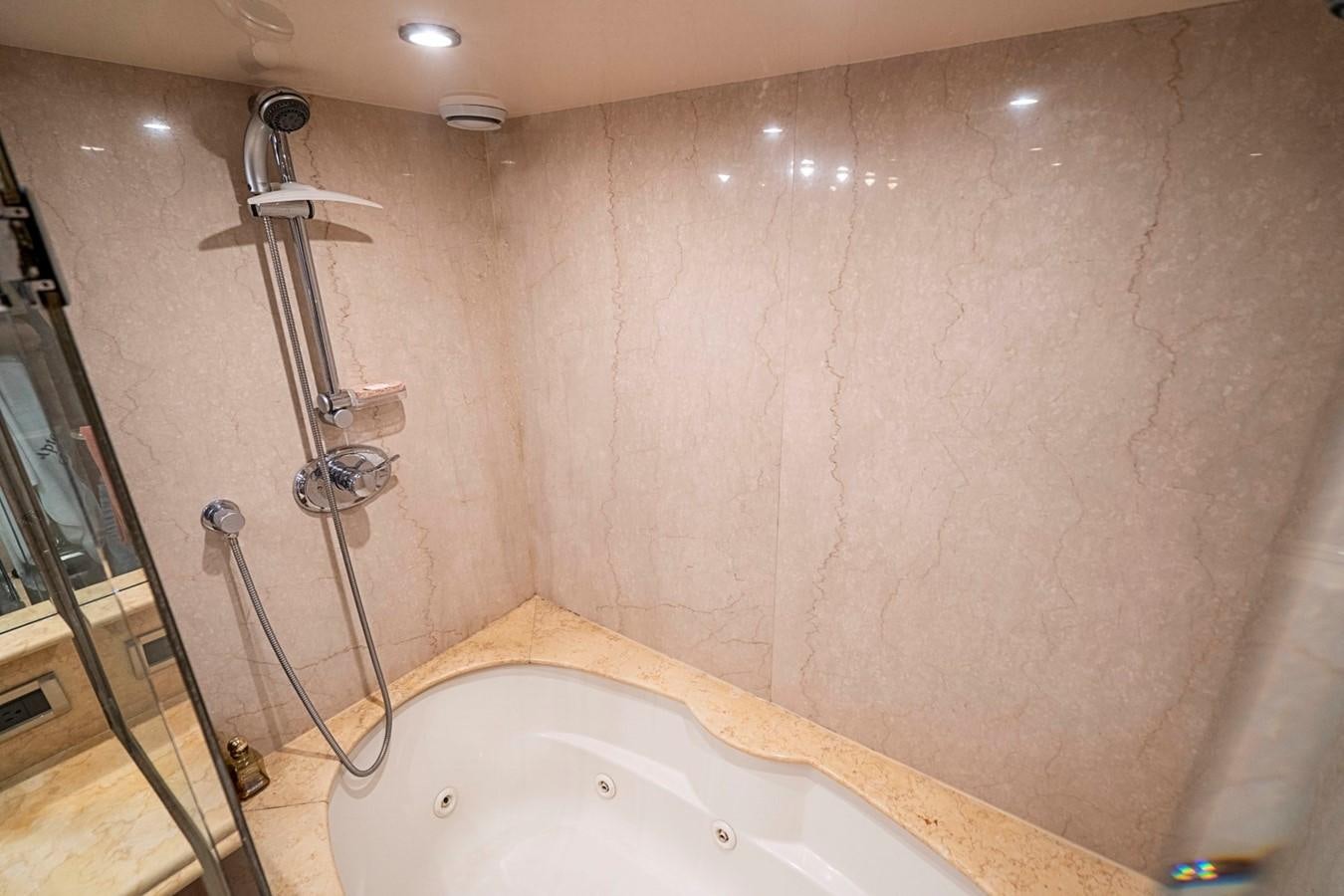 a shower with a tub aboard RENDEZVOUS Yacht for Sale
