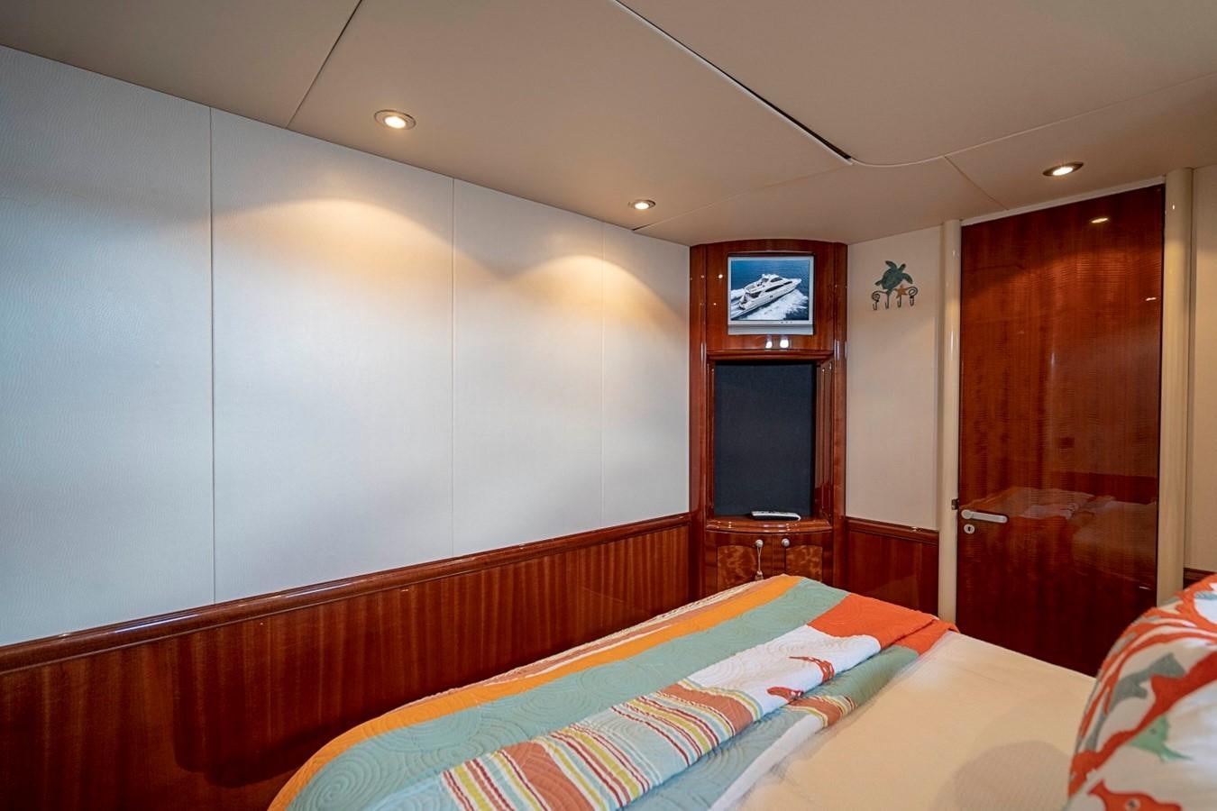 a bed with a colorful comforter aboard RENDEZVOUS Yacht for Sale
