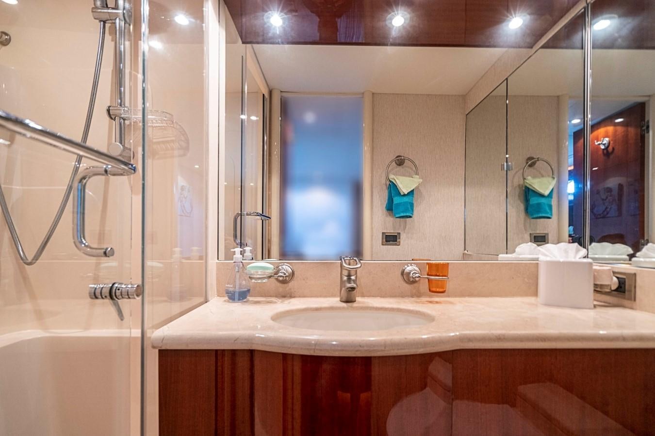 a bathroom with a large mirror aboard RENDEZVOUS Yacht for Sale