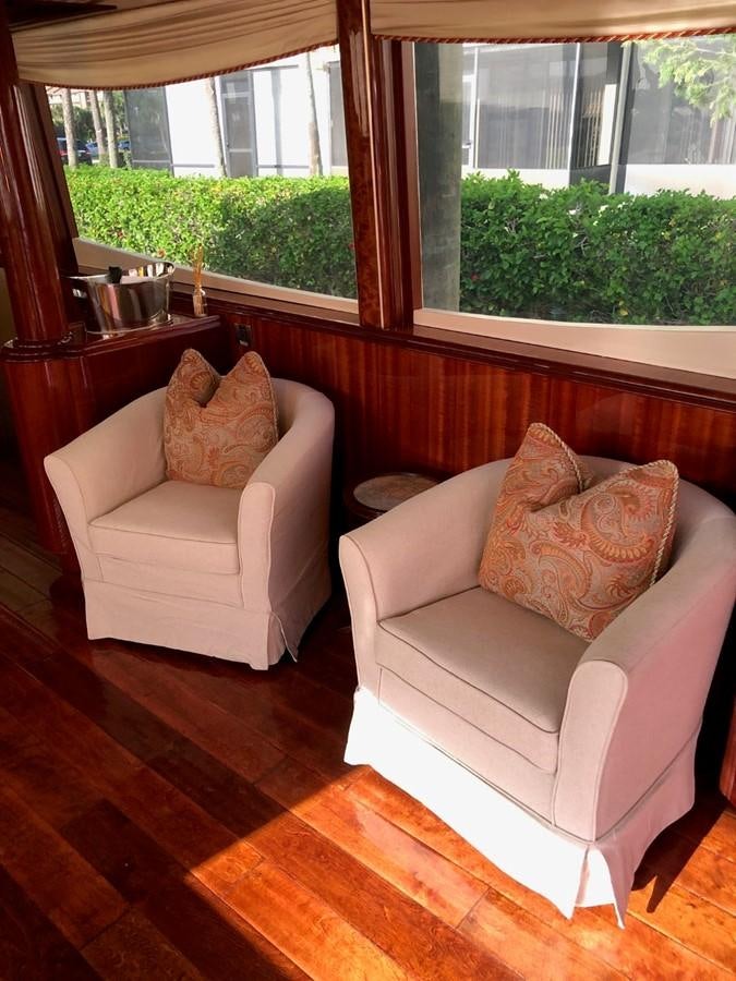 a couple of couches in a room with a window aboard RENDEZVOUS Yacht for Sale