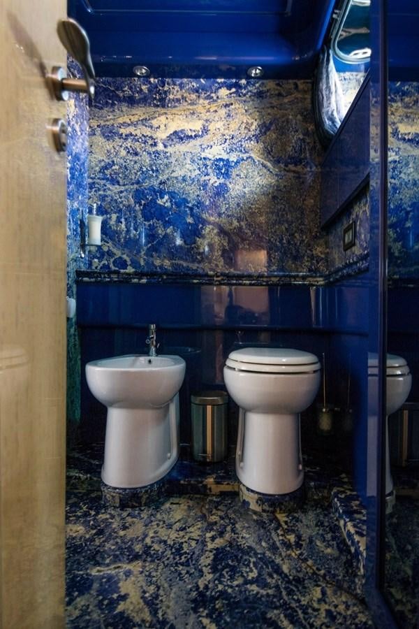 a bathroom with a blue wall aboard ROSIQUE Yacht for Sale