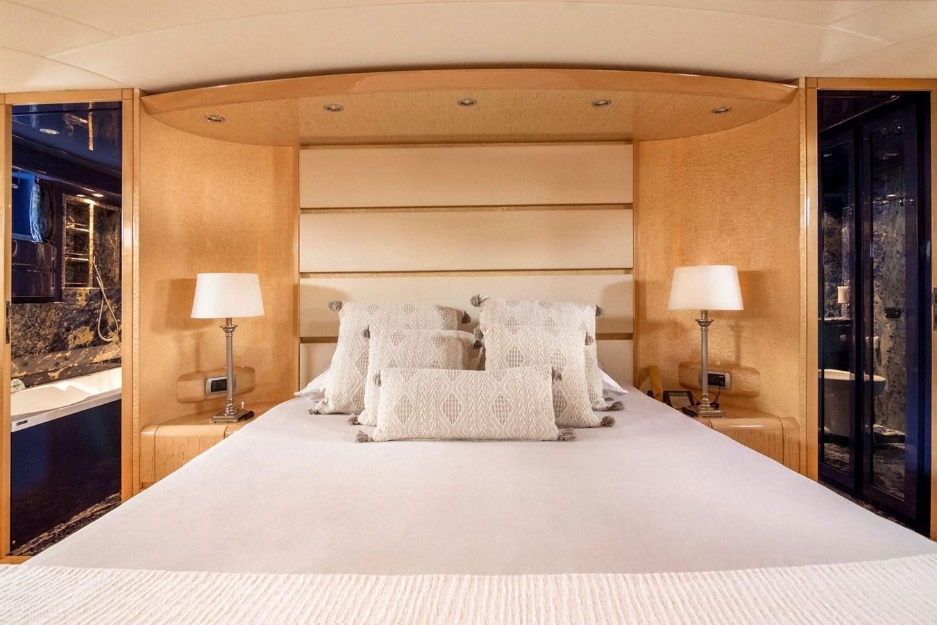 a bed with white sheets aboard ROSIQUE Yacht for Sale