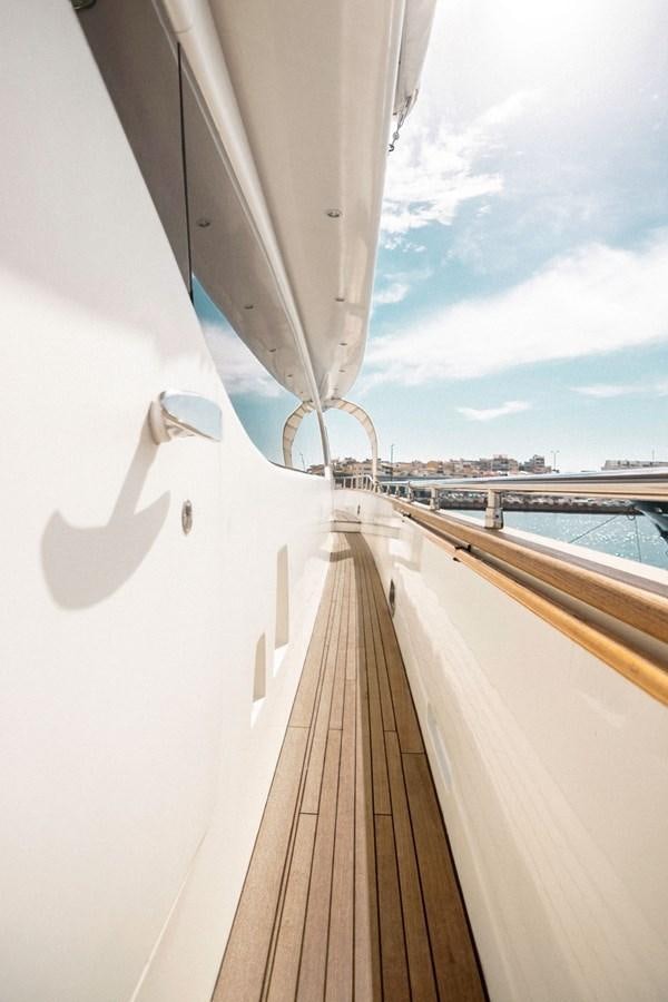 a white wall with a white railing and a white wall with a white arch and a blue sky aboard ROSIQUE Yacht for Sale