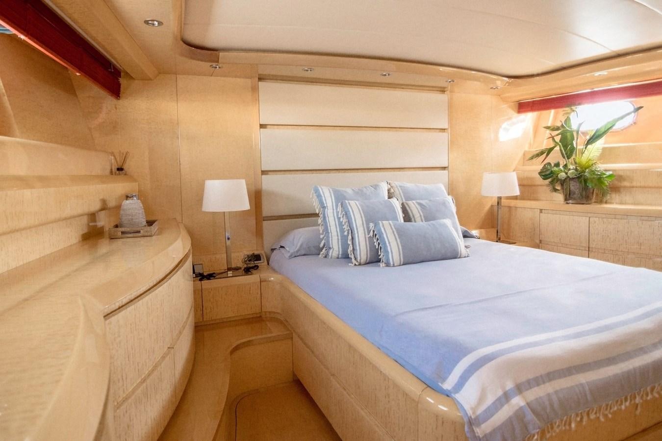 a room with a bed and a lamp aboard ROSIQUE Yacht for Sale