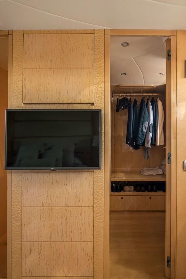 a closet with clothes on the wall aboard ROSIQUE Yacht for Sale