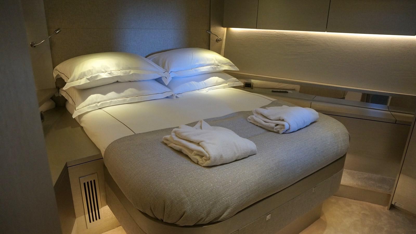 a bed with white sheets aboard ALILEA Yacht for Sale