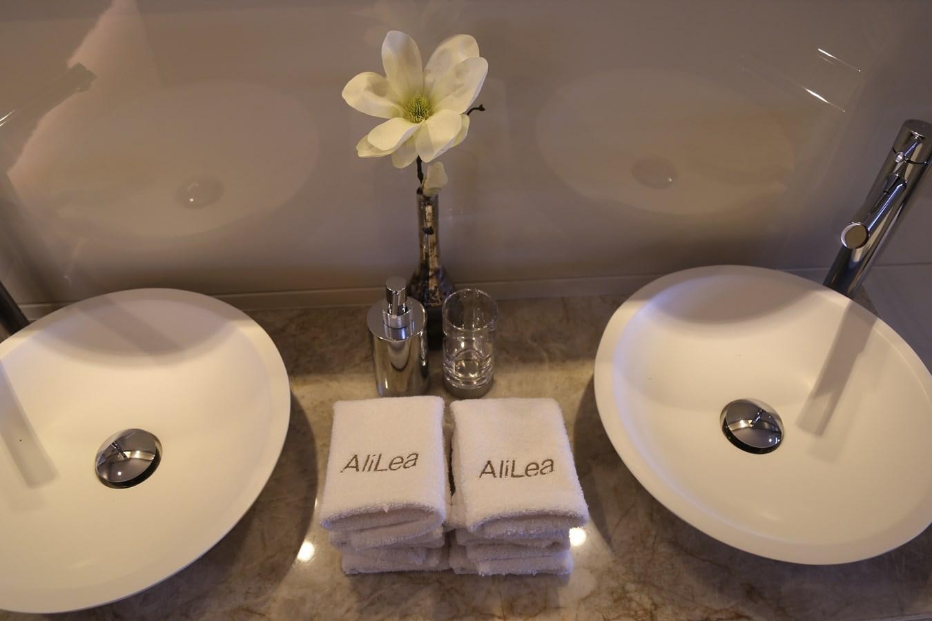 a bathroom sink with towels and toilet paper aboard ALILEA Yacht for Sale