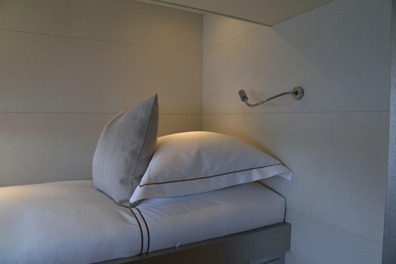 a bed with a white pillow aboard ALILEA Yacht for Sale