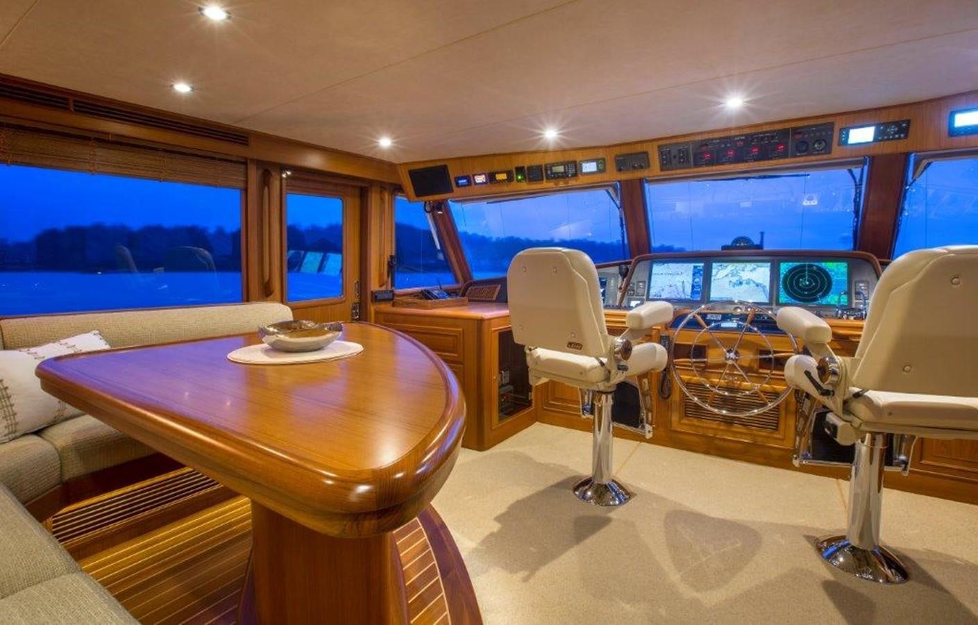 a room with a table chairs and a tv aboard FLEMING 78 - NEW BUILD Yacht for Sale