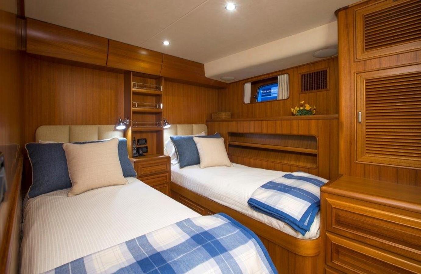 a room with a bed and a wood wall aboard FLEMING 78 - NEW BUILD Yacht for Sale