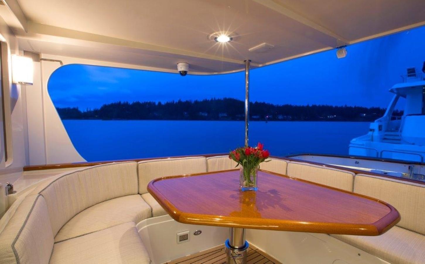 a table with flowers on it aboard FLEMING 78 - NEW BUILD Yacht for Sale
