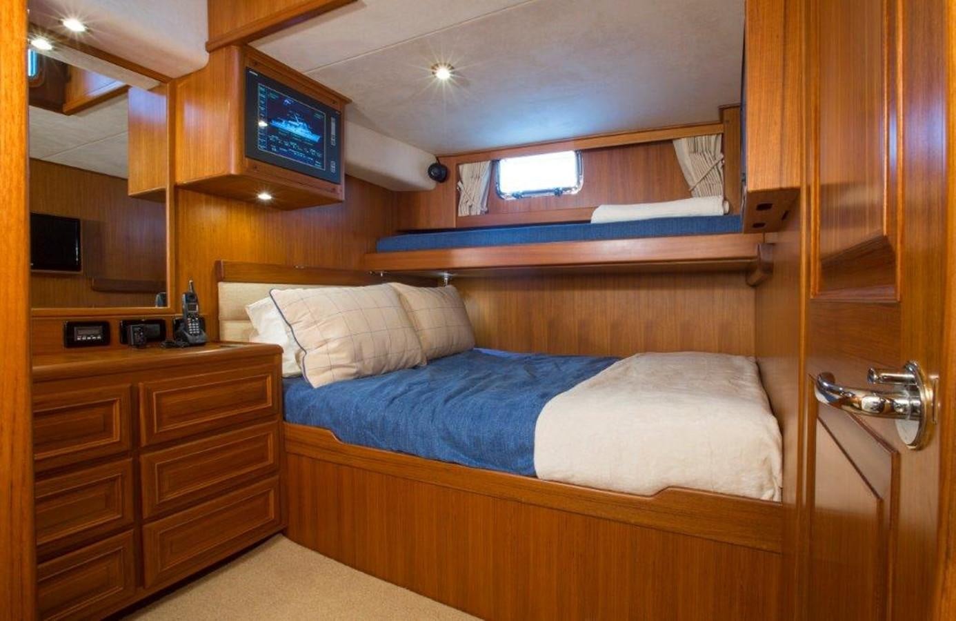 a bed with a television on the wall aboard FLEMING 78 - NEW BUILD Yacht for Sale