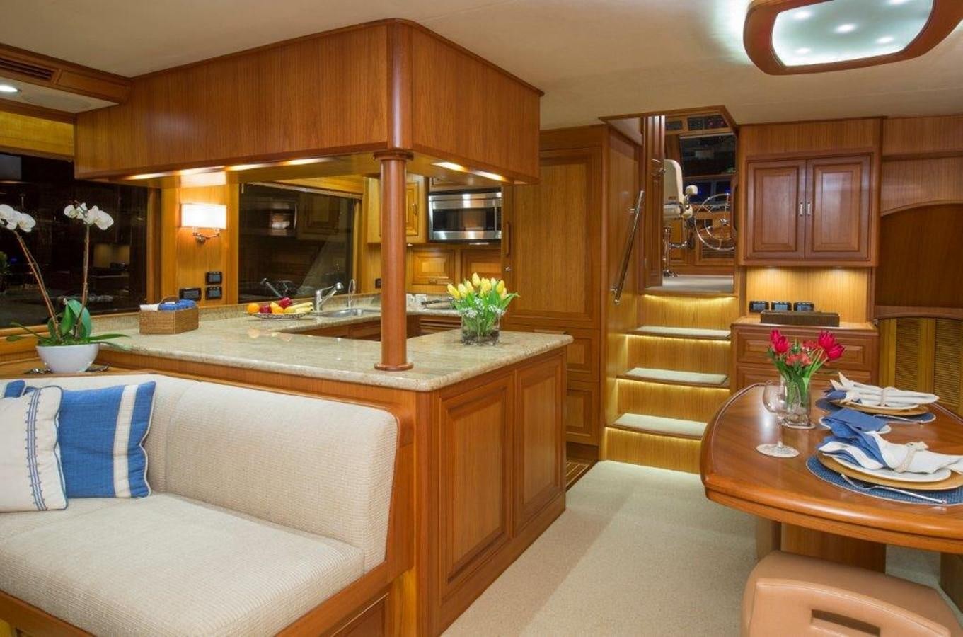 a living room with a couch and a table aboard FLEMING 78 - NEW BUILD Yacht for Sale