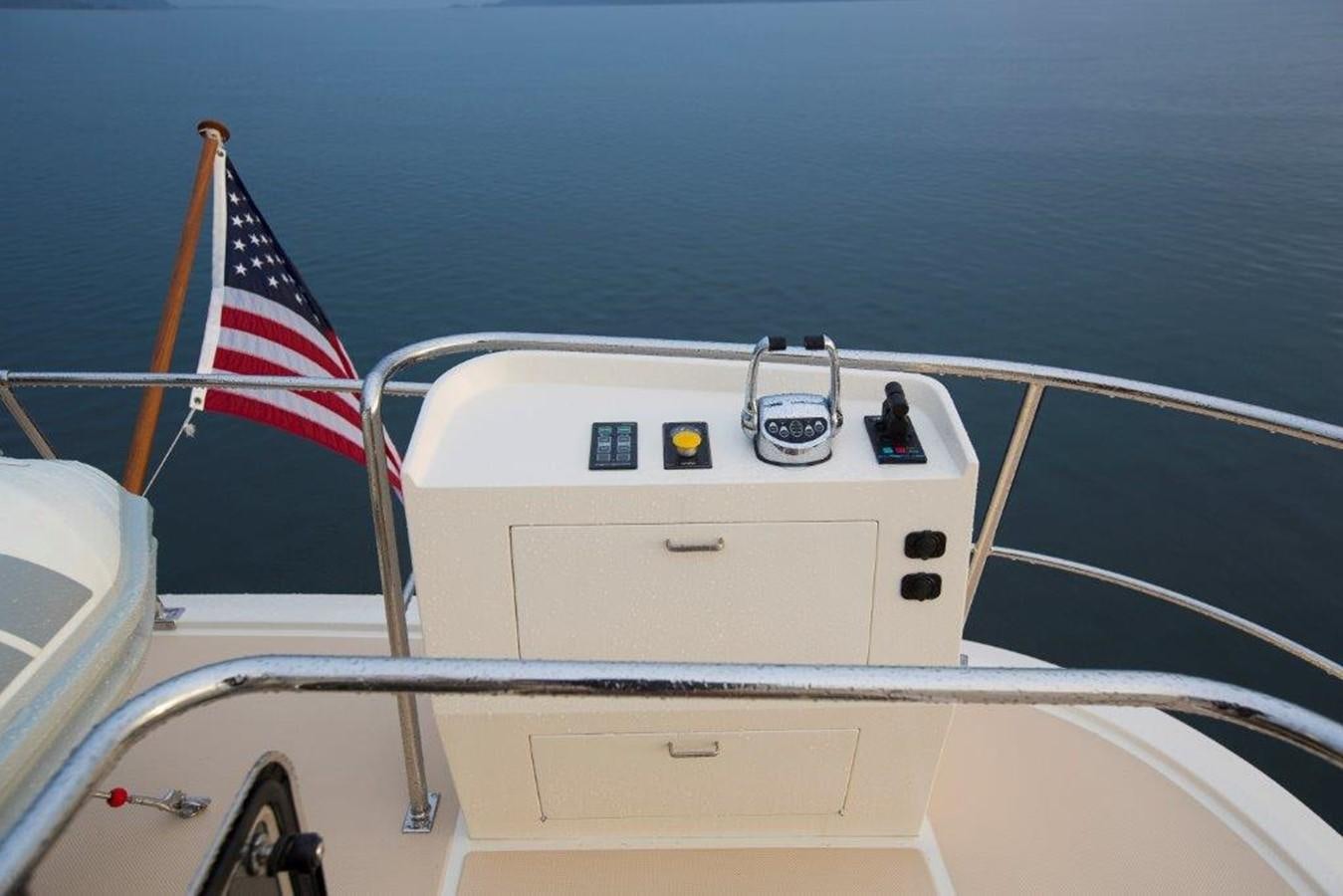 a boat with flags on it aboard FLEMING 78 - NEW BUILD Yacht for Sale