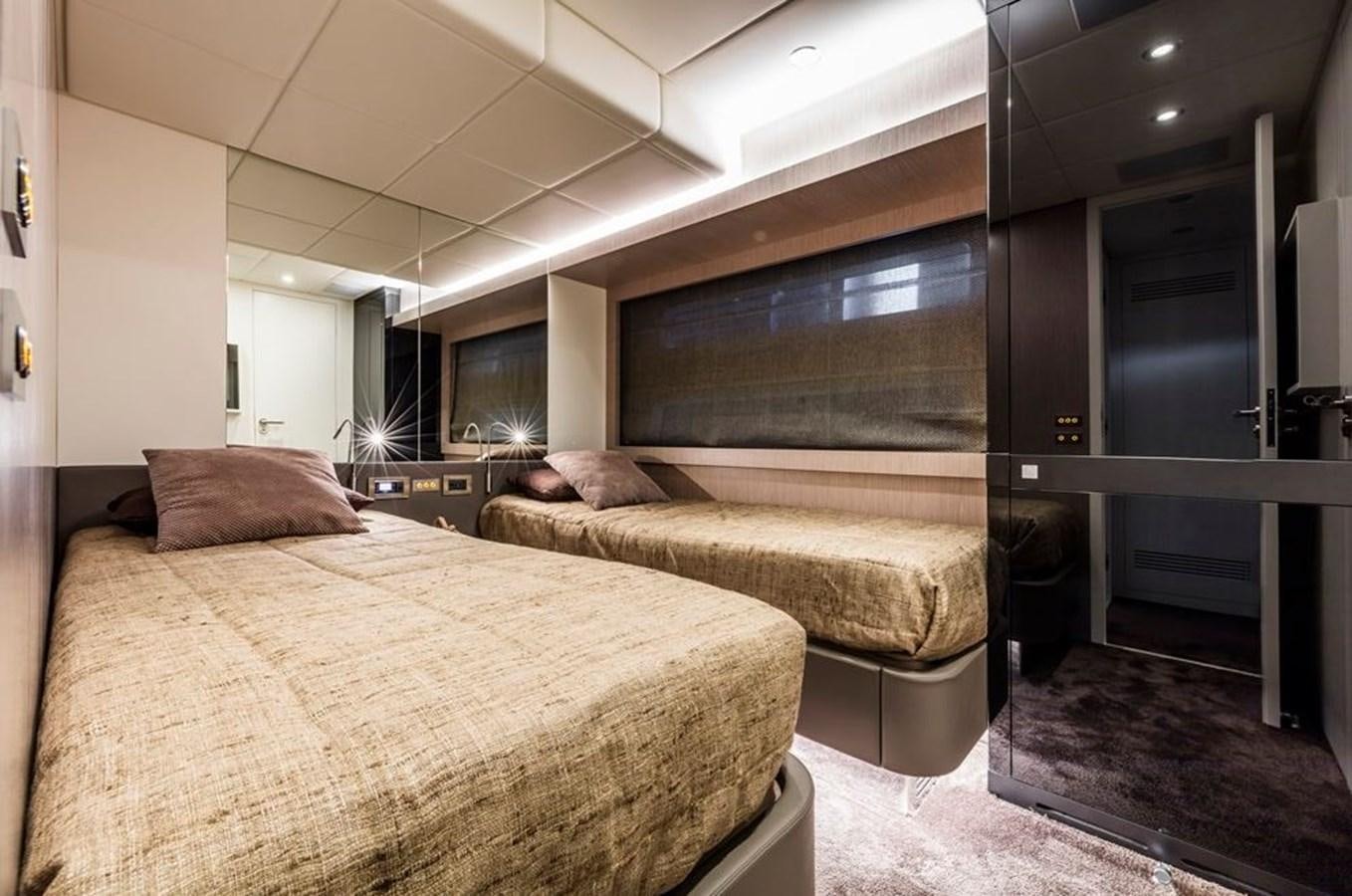 a bedroom with a bed and a mirror aboard BULL Yacht for Sale