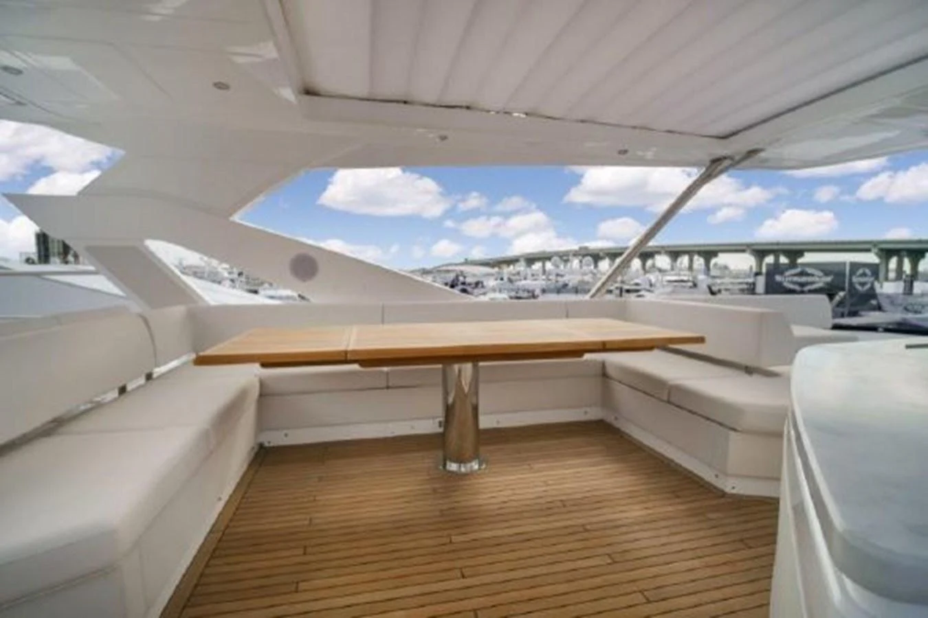 a room with a wood floor and a large window with a view of the city below aboard SOLAIRE Yacht for Sale