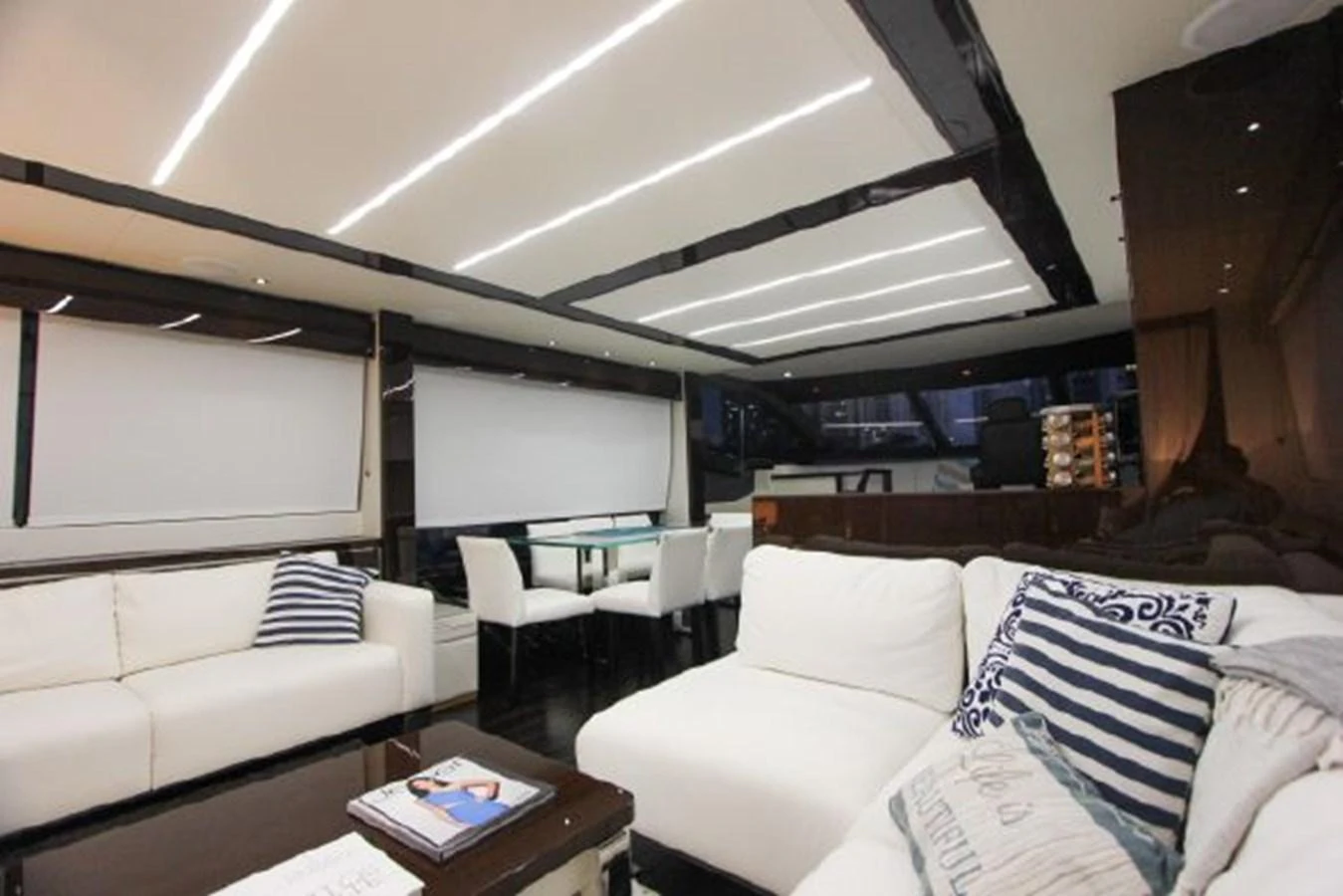 a living room with white couches aboard SOLAIRE Yacht for Sale