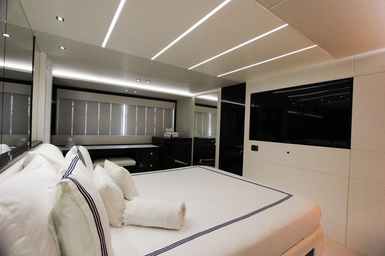 a room with a bed and a large window aboard SOLAIRE Yacht for Sale