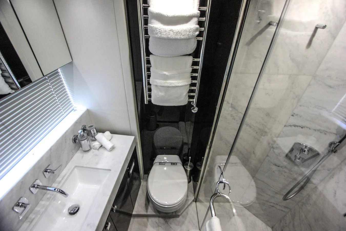 a bathroom with a sink and a toilet aboard SOLAIRE Yacht for Sale