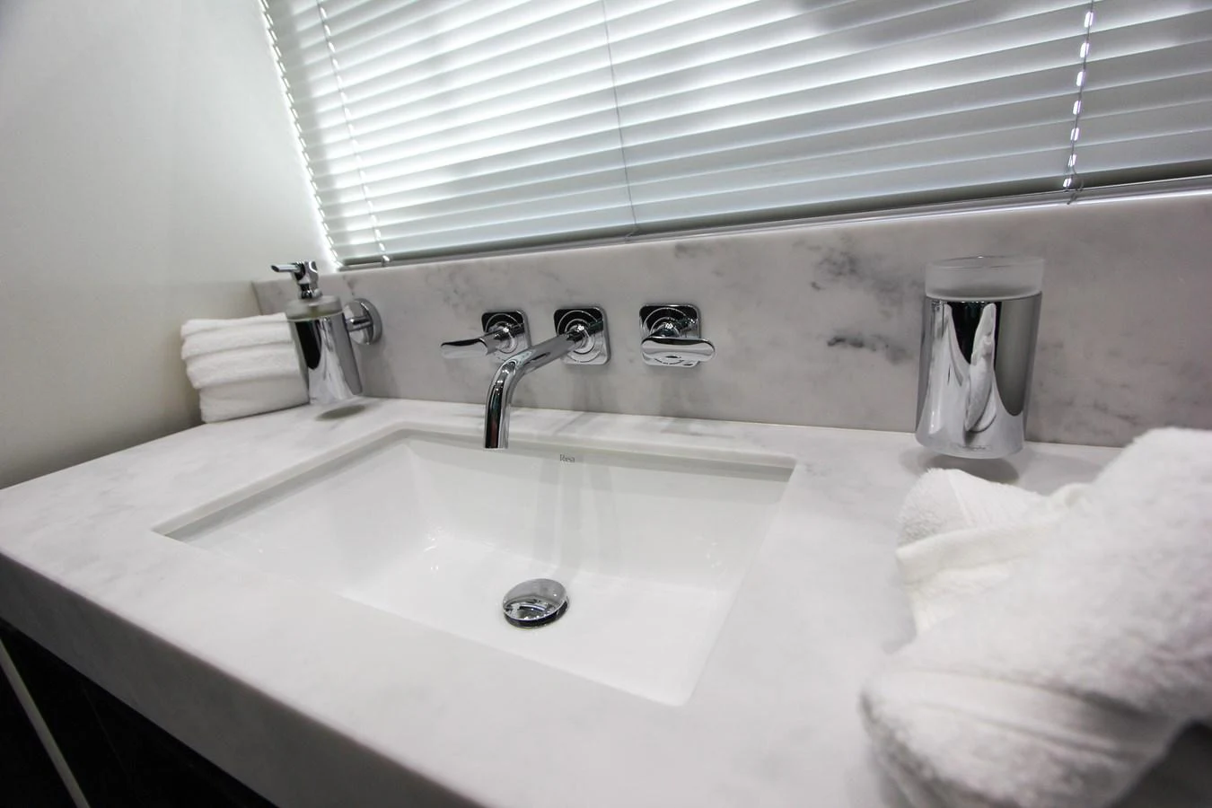 a bathroom sink with towels aboard SOLAIRE Yacht for Sale