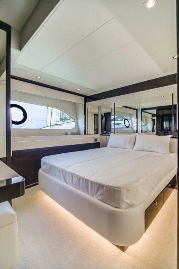 a room with a bed and a large window aboard SOLAIRE Yacht for Sale