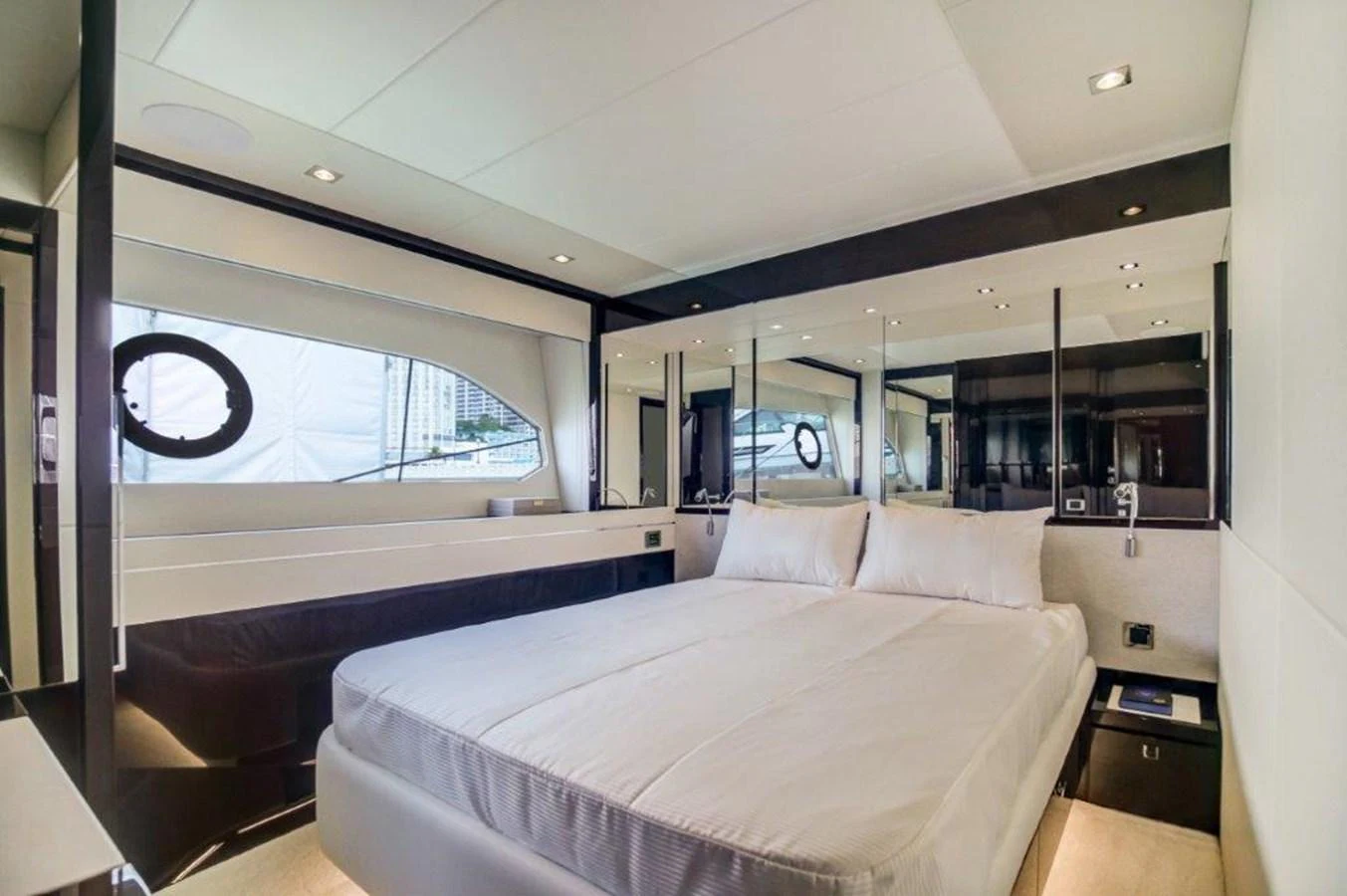 a room with a bed and a large window aboard SOLAIRE Yacht for Sale