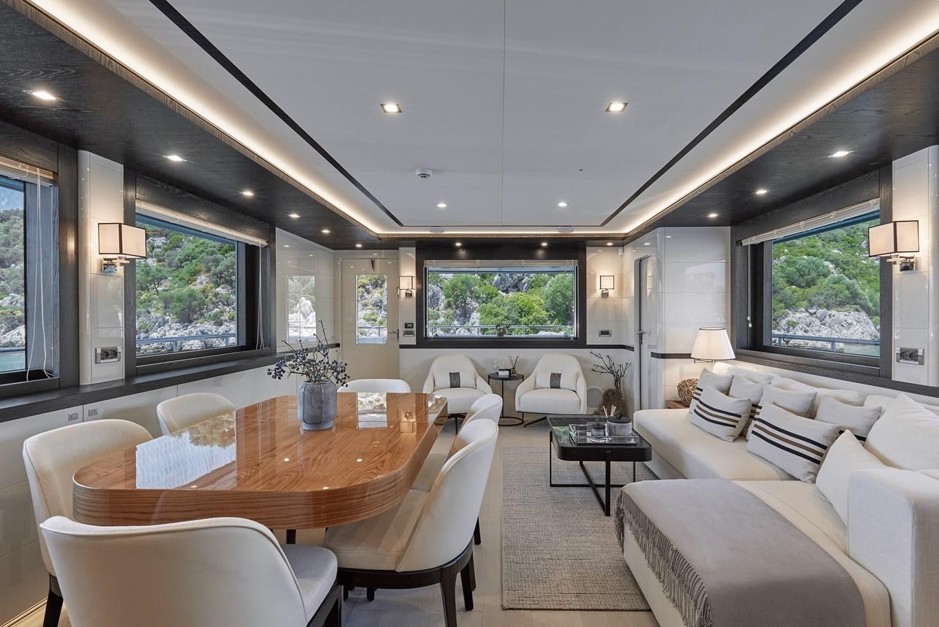 a large living room with a large table and chairs aboard BERING 88/05 Yacht for Sale