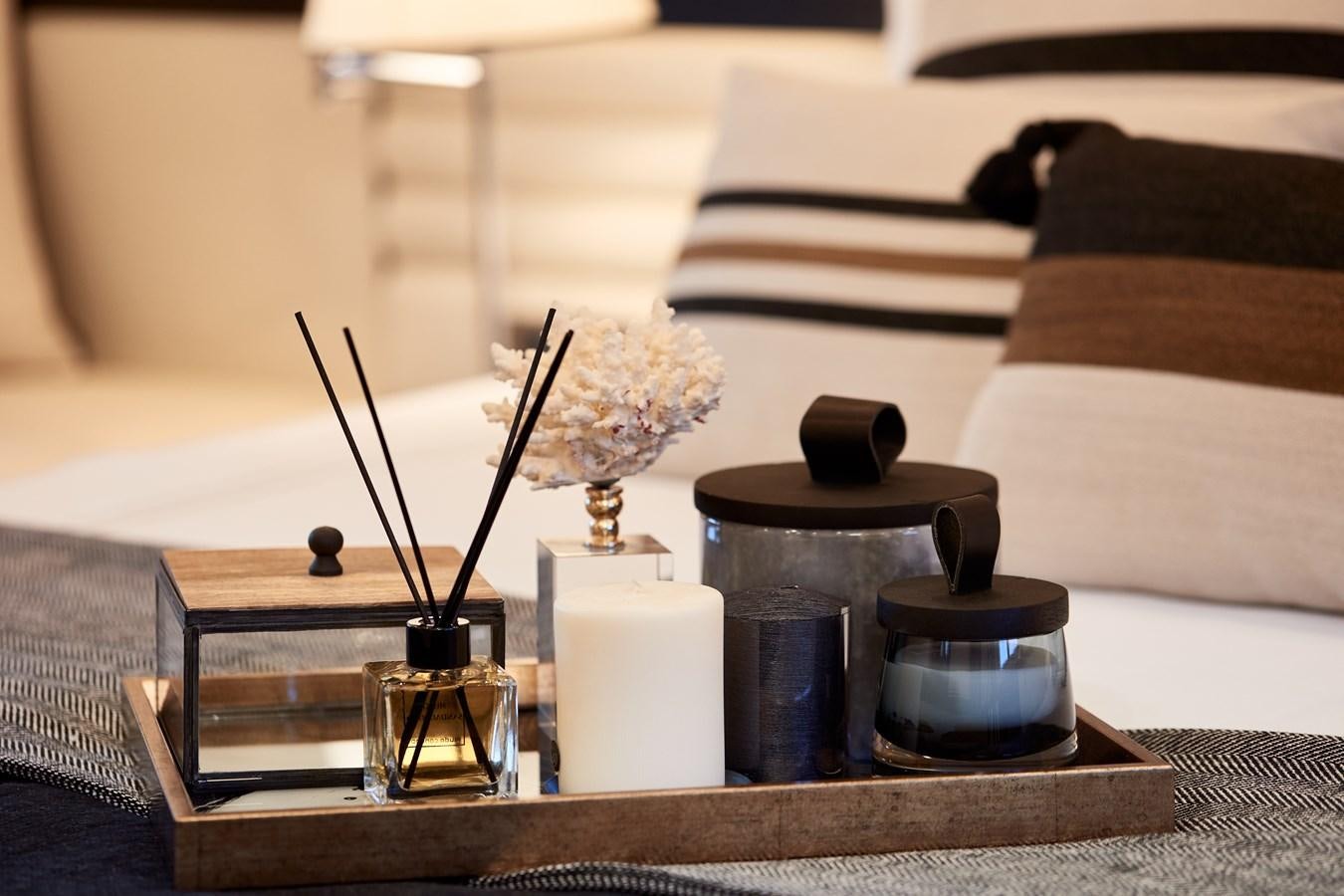 a table with a vase and candles aboard BERING 88/05 Yacht for Sale