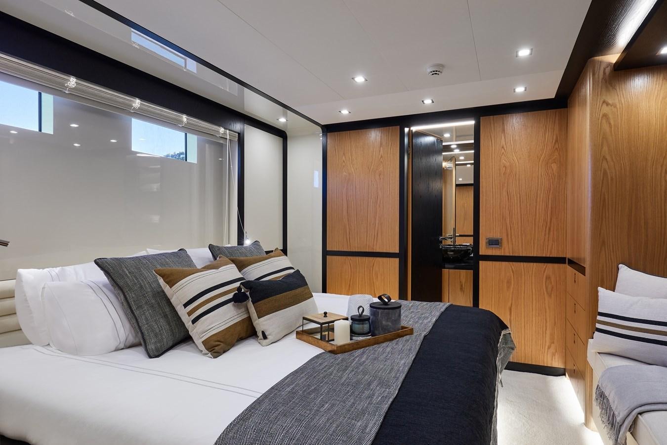 a room with a bed and a window aboard BERING 88/05 Yacht for Sale
