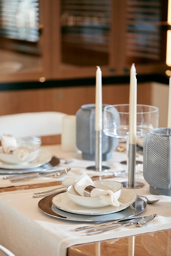 a candle on a plate aboard BERING 88/05 Yacht for Sale