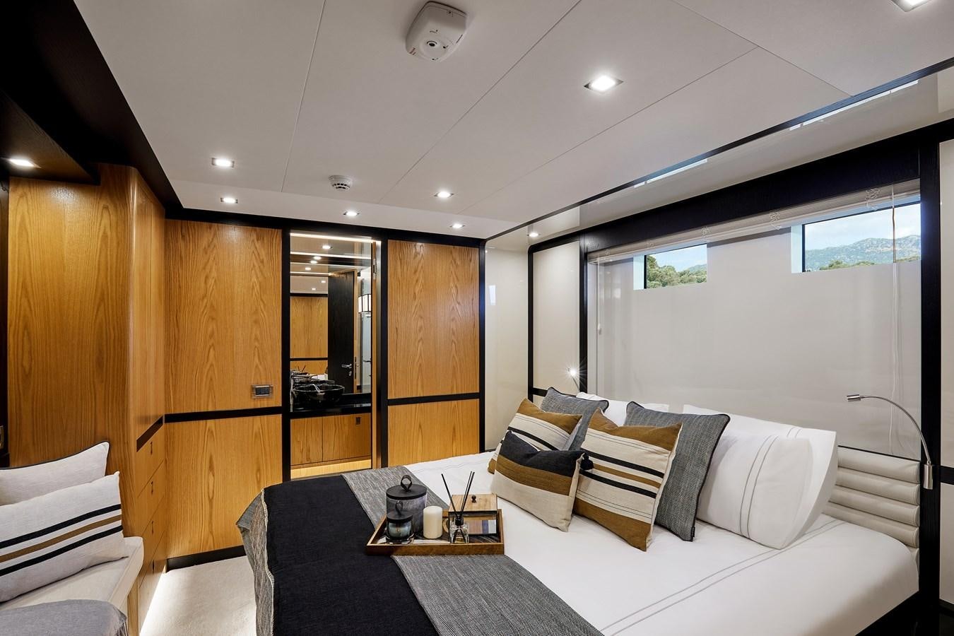 a room with a bed and a table aboard BERING 88/05 Yacht for Sale
