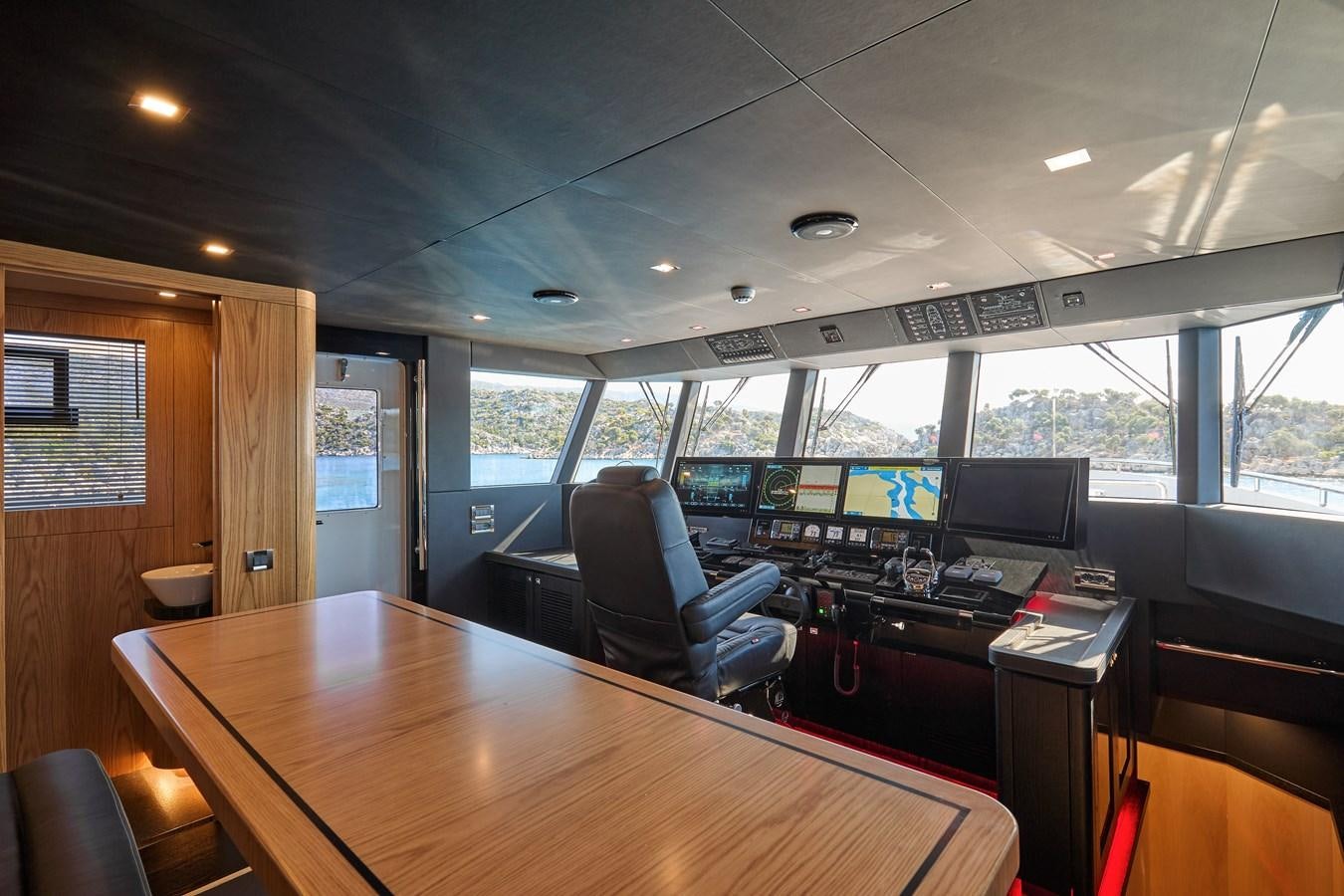 a room with a table and chairs aboard BERING 88/05 Yacht for Sale