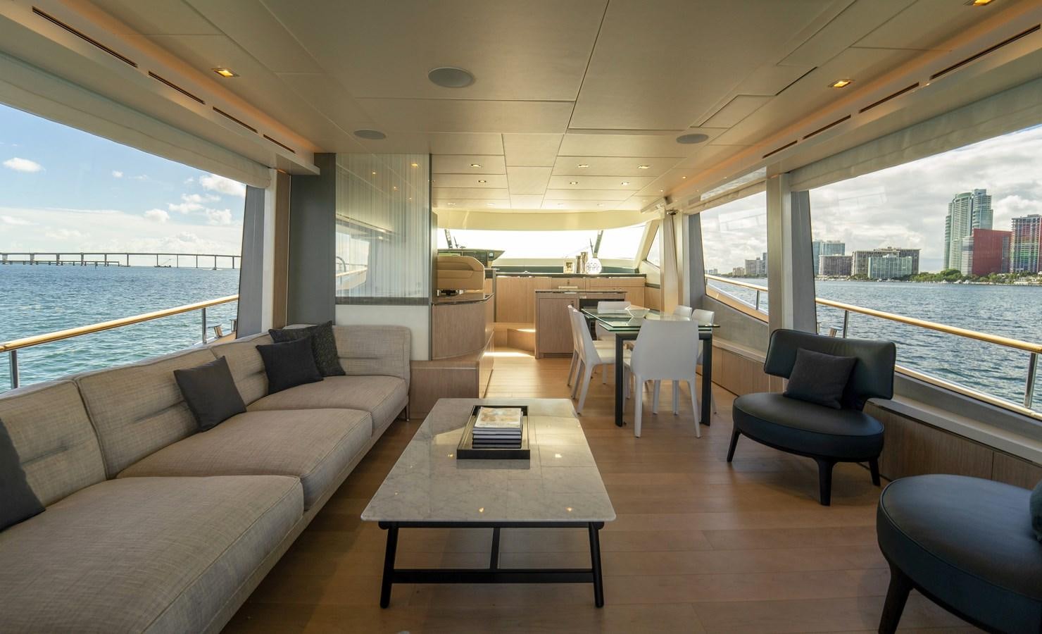a living room with a couch and a table aboard MONTE CARLO YACHTS MCY 76 Yacht for Sale