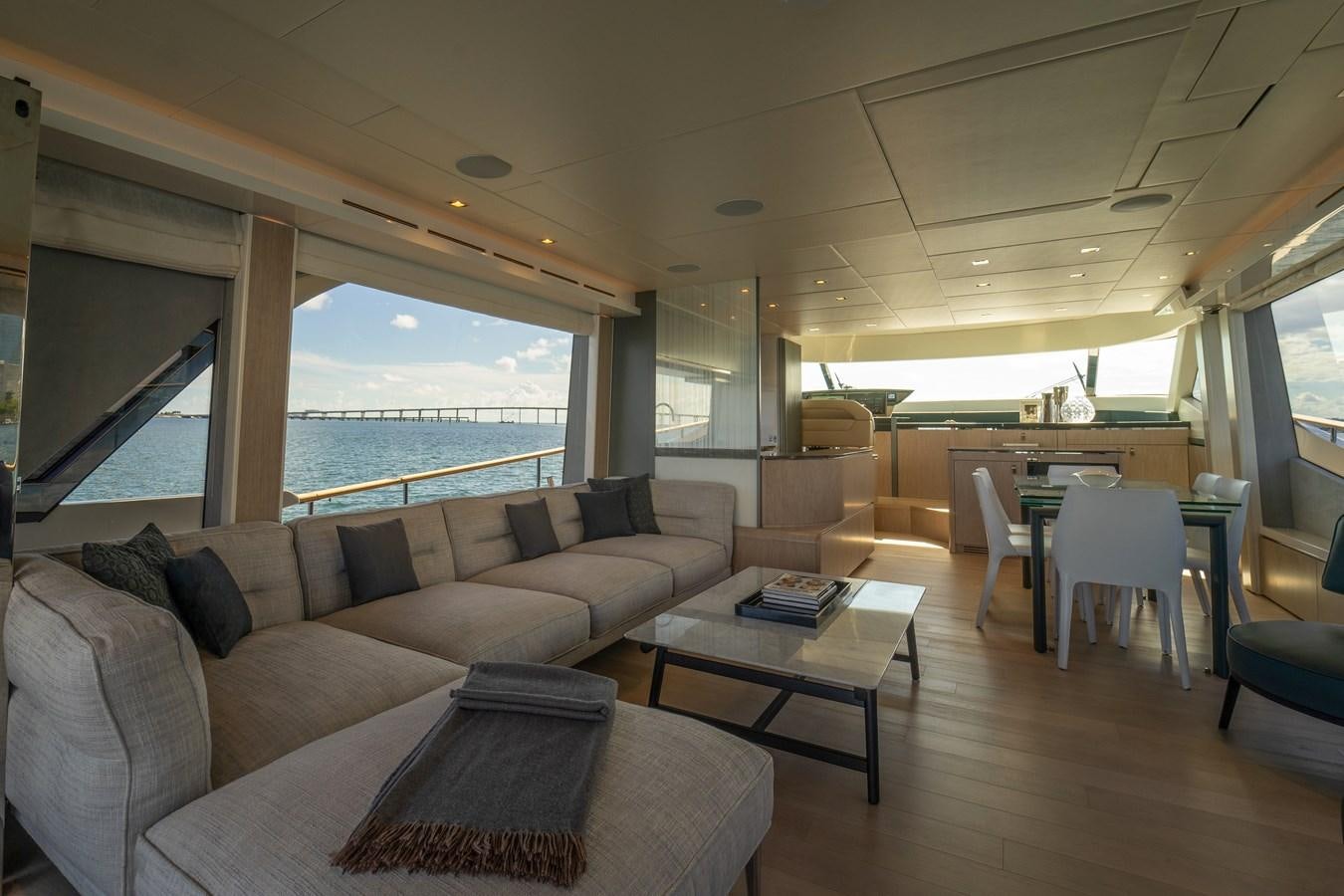 a living room with a large window aboard MONTE CARLO YACHTS MCY 76 Yacht for Sale