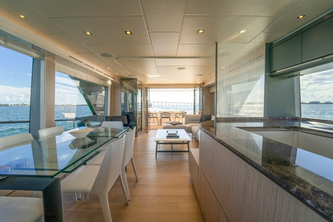 a room with tables and chairs aboard MONTE CARLO YACHTS MCY 76 Yacht for Sale