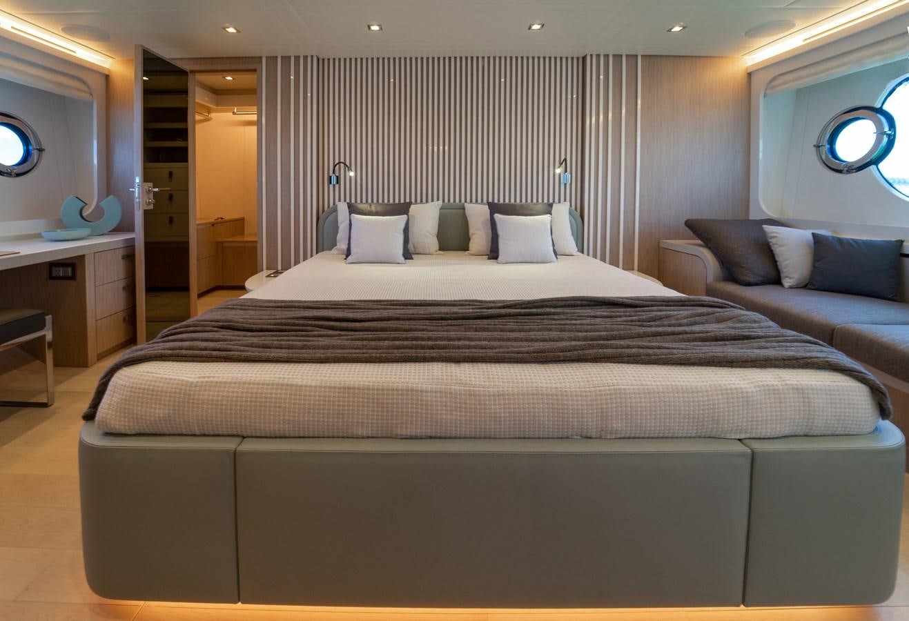 a bed with a black and white bed spread aboard MONTE CARLO YACHTS MCY 76 Yacht for Sale