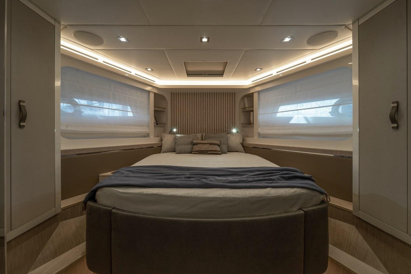 a room with a bed and a window aboard MONTE CARLO YACHTS MCY 76 Yacht for Sale