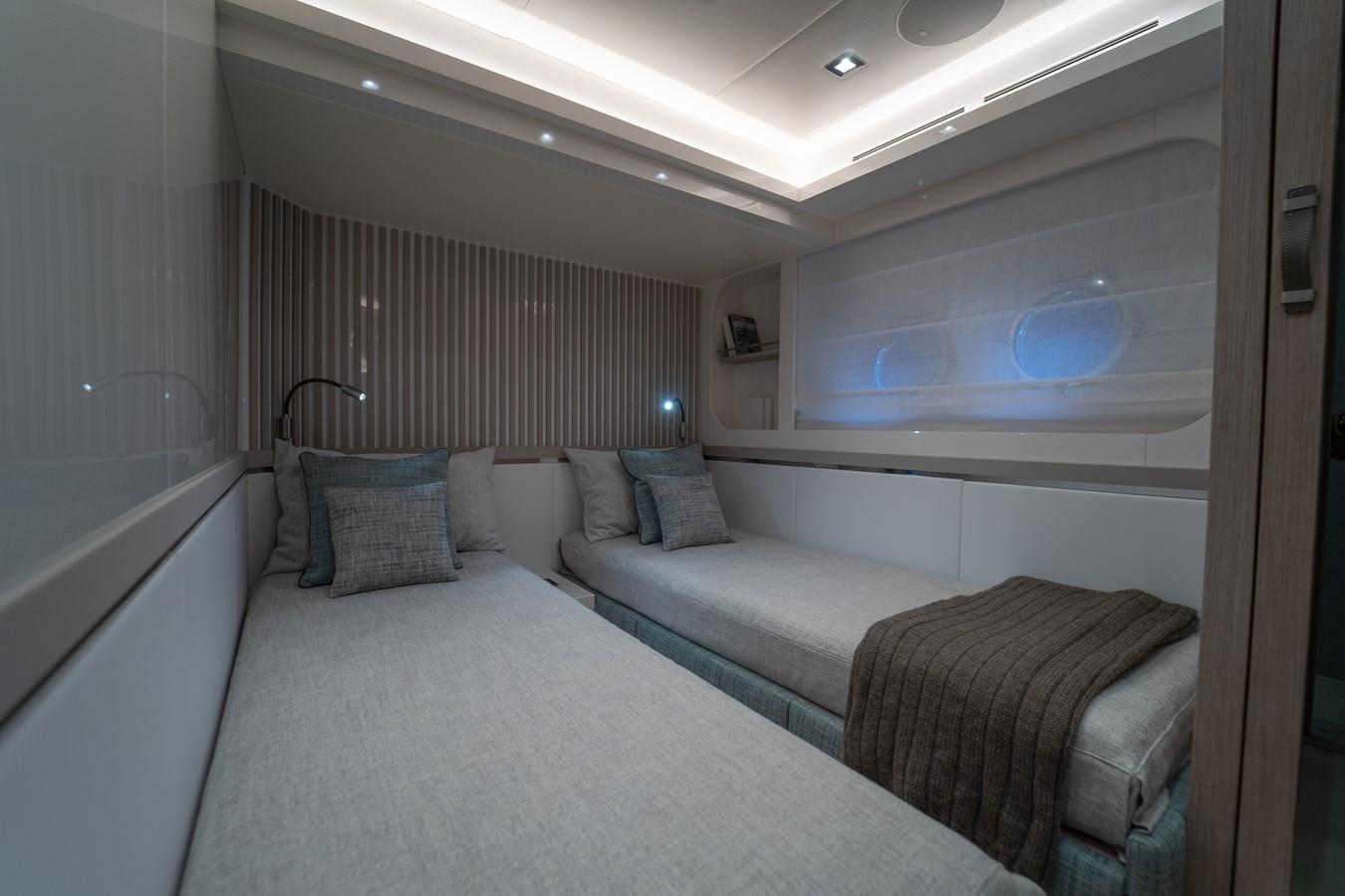 a room with two beds aboard MONTE CARLO YACHTS MCY 76 Yacht for Sale