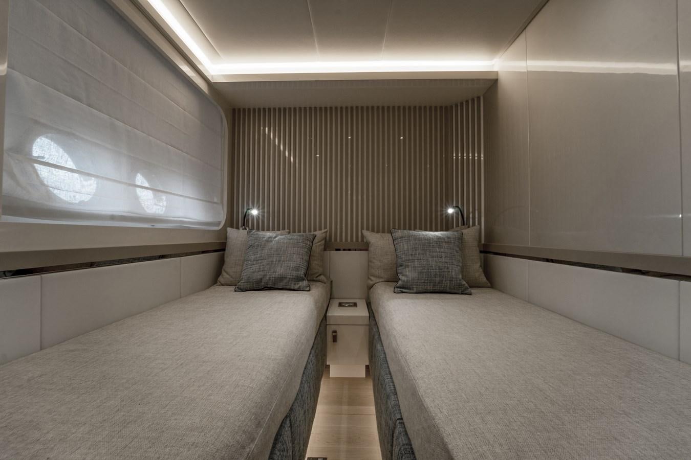 a room with two beds aboard MONTE CARLO YACHTS MCY 76 Yacht for Sale