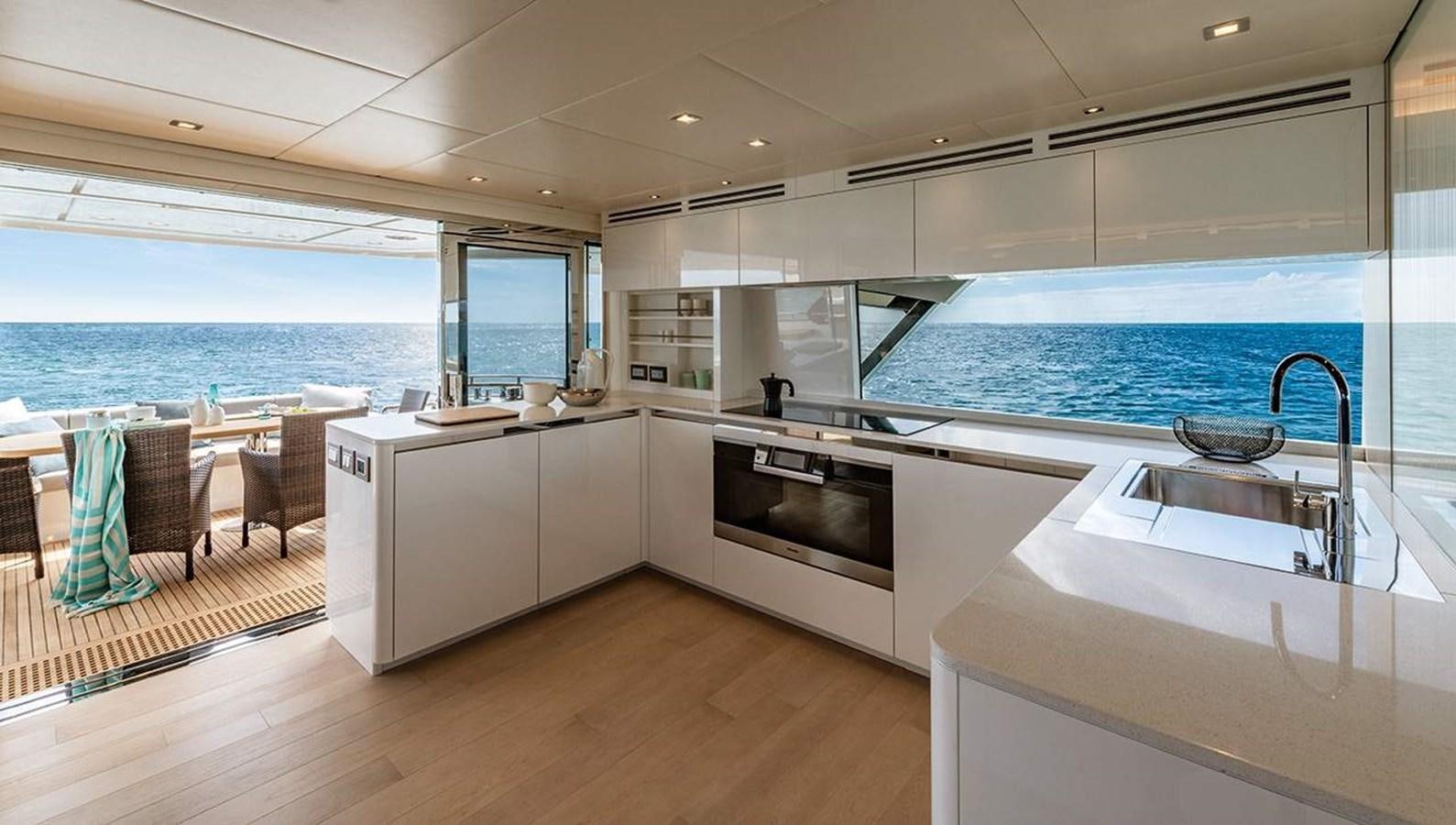 a kitchen with a large window overlooking the ocean aboard MONTE CARLO SKYLOUNGE  Yacht for Sale