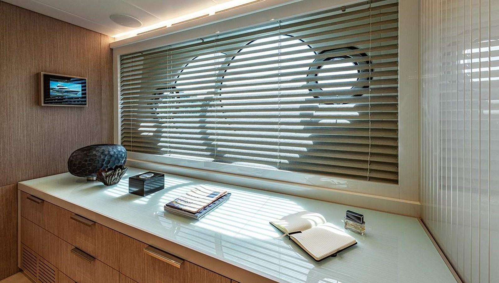 a desk with a computer and books on it aboard MONTE CARLO SKYLOUNGE  Yacht for Sale